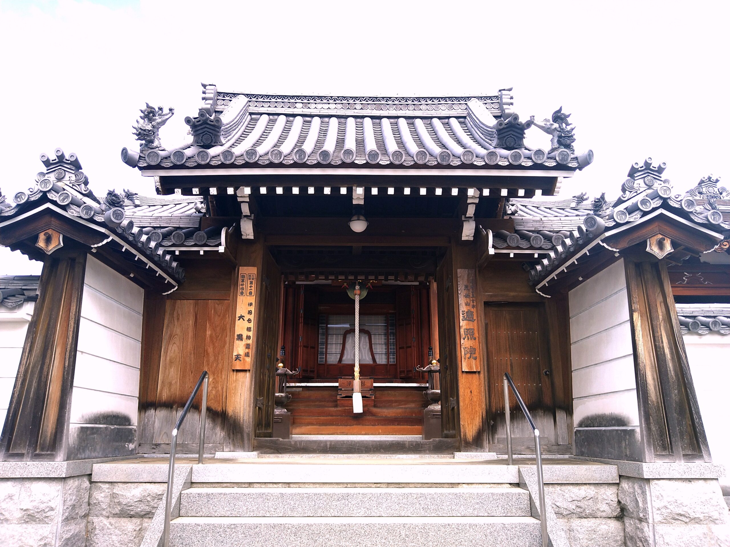 立派な瓦屋根と木造建築が特徴的な寺院の本堂外観